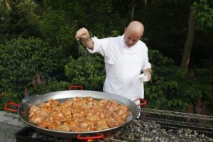 Chef Pierre in control of the grill and the gigantic new paella pan