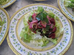 The greens were tossed with a lemony vinaigrette and the radish salad was placed on top.