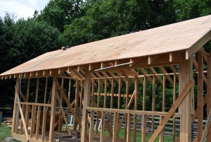 The first side of the roof sheathing is installed on the rafters. It is important to make sure the first piece of plywood is nailed in perfectly - it will be the foundation for all the other pieces that are installed.