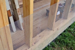 Wire mesh is placed along the lower perimeter of the structure to keep out small uninvited creatures.