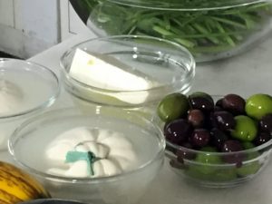 This recipe calls for one of three cheeses - feta, burrata, or mozzarella, and some olives. When buying fresh mozzarella or feta, store it in cold water in a covered container in the fridge.