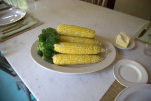 A platter filled with some of the season's freshest corn and broccoli.