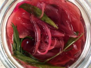 The pickled red onions have a beautiful color from the red wine vinegar. It adds such a nice color for this green salad.