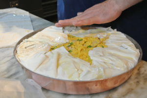 Pierre folds the excess phyllo up and over the filling.