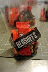 Shqipa places several candies into a cellophane bag - these bags are available online and can be so helpful for a lot of crafts.