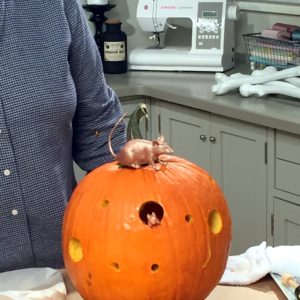 Then, just fill the holes with mice. Secure them with hat pins, and place the pumpkin on an adult table or the kids' table.