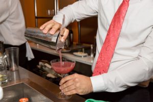 This bartender is pouring one of the evening's themed cocktails, a winter margarita made with Sauza 901 tequila.