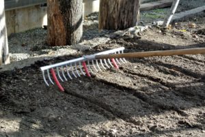 It's a cleverly designed tool for making multiple straight rows in one pass. The depth of the furrows depends on the amount of pressure placed on the rake as it moves through the soil.