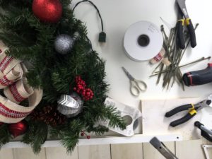 For the Tree-Shaped Wreath, we used scissors, some wood strips and wing nuts to shape the garland. Watch our special Facebook LIVE demo to see how we did it - it's so easy.