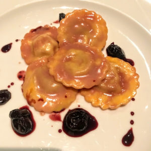 This is the duck ravioli - cherries garnished the plate.