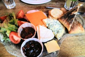 We had a ploughman's lunch, also known simply as "ploughman's.- an English cold meal including cheese, pickles and bread. Sometimes, these lunches also include apple, boiled eggs, ham, and pickled onions.