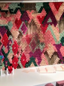 Bryan's booth included this backdrop of colored paper pieces curled and inserted into the holes of wire fencing - so creative and eye-catching.