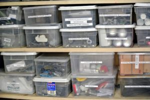 In a storage closet, we keep a lot of the smaller supplies and tools - all organized in labeled clear plastic bins.