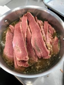 And then transferred back into the broth to keep warm. You can also place the corned beef into a serving vessel and pour some of the broth on top to keep it warm.