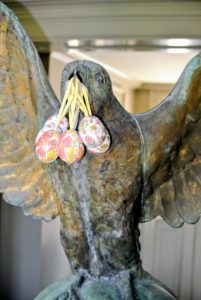 On my front hall table, decorative eggs hang from the mouth of the giant bird.
