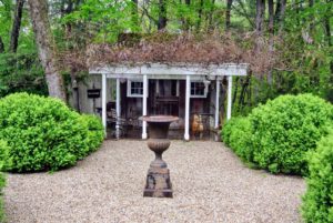 Across from the main house is a charming garden shed. The walking paths are covered with quarter-inch round stone - a beautiful ground cover for the bold green of the boxwood.