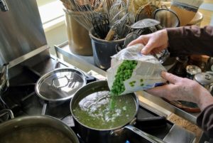Here I am boiling some peas - I am using four bags of frozen peas. My dogs love peas. Green peas are a good source of the B vitamin Thiamin, phosphorous, and potassium. Don't overcook them - they only take a couple of minutes.