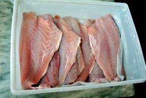 When selecting fish, the fish should not give off an odor. The skin should be shiny and adhere tightly to the flesh.