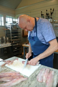 Pierre cuts the fish into sections for our bouillabaisse.
