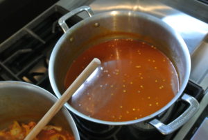 After the bouillabaisse is cooked, it is poured through a sieve to remove all the solids. Then the liquid is returned to the pot. Here is the wonderful rich-colored bouillabaisse broth.