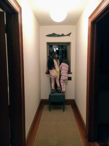 Here are the children on a chair at the end of the "dorm" hall. They are looking at the moon and stars. (Photo by Kate Berry)