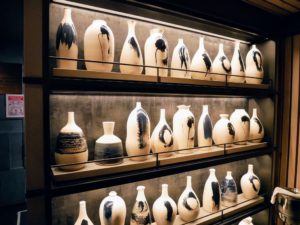 These handmade ceramic sake carafes by Canadian artist, Pascale Girardin, adorn two walls of the sake area.