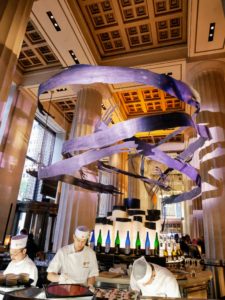 The upstairs includes a 4,500 square-foot street-level bar and lounge with the 350-foot wooden ash brushstroke sculpture designed and conceived by Rockwell Group and realized in collaboration with New York-based artist John Houshmand.