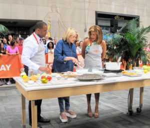 Here I am with NBC news anchors, Craig Melvin and Hoda Kotb. I am showing them how to make the fish fry batter. The dry ingredients include flour, cornstarch, baking powder and salt. Watch the segment to find out what special ingredient I use next.