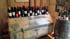 This collection of wine is on top of a tumbling machine. The machine was originally used to polish the mill's tools after they had been turned.