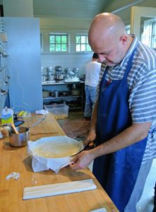 Chef Pierre cuts off any excess phyllo dough from the sides of the pans.