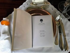 A copy of the evening's menu is set-down at every place setting.