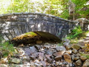 Constructed of dark stained rock, this is one of the more remote bridges. It has a small single round arch and is 40-feet long with a span of 20-feet.