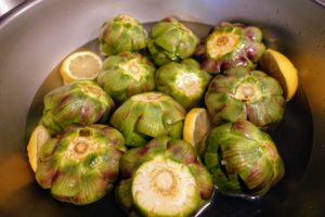 As each artichoke was prepared, it was placed in water with citrus slices to keep them from browning.