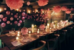 The room looked very special for Maureen - all the guests loved it. We used lots of balloons in different sizes, along with Martha Stewart Crafts paper flowers hung from the wooden beams.
