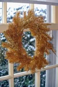 Metallic wreaths are hung in every window.