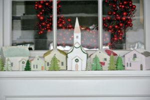 The mantle in the Tenant House is decorated with a Christmas village scene.