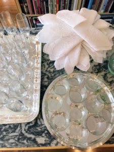 I love this view of the napkins folded and positioned in a circular pattern on top of a Jadeite cake stand.