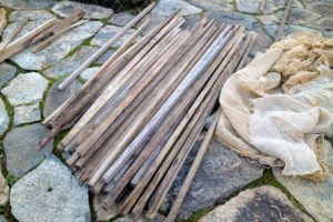 We also use wooden stakes to support the burlap. These one-and-a-half by one-and-a-half inch pieces are milled right here at my farm and can be used again and again.