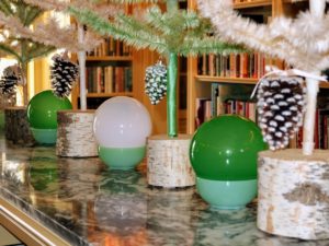 Glass globes sit in simple Jadeite bowls. These trees are in natural wood tree stands, also cut right here at the farm.