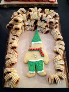 Here's a winking sugar cookie gnome and buccellati. Buccellati cookies are Sicily's best-known Christmas cookie - a thin pastry wrapped around a filling of dried figs and nuts.