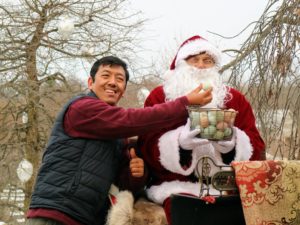 Dawa, who is in charge of caring for all my outdoor birds, brought up the day's chicken eggs and took this quick photo with Santa.