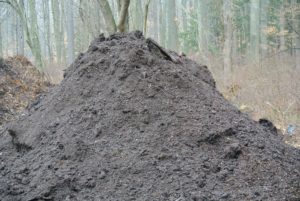 My compost piles include this dark organic matter made up of manure and biodegradable materials. Compost is ready to use after two years. During this time, it is mixed with water, oxygen, carbon, and nitrogen, which break down the organic matter.
