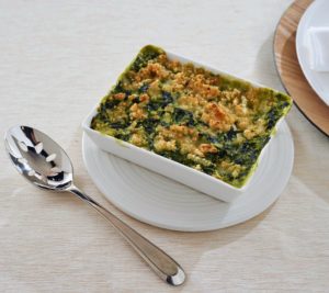 Here's my creamy spinach casserole with chopped spinach, butter, whole milk, and sour cream. This is also topped with panko bread crumbs, butter, and gruyere cheese - it's great for any special occasion.