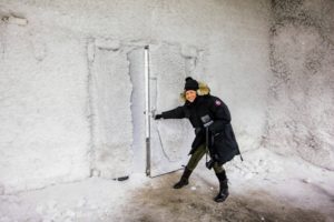 Here I am opening the door to the Vault Room. These vault rooms are located more than 425-feet from the entrance and nearly 200-feet below the surface of the top of the mountain. The double door and the surrounding walls are covered with thousands of tiny ice crystals. (Photo by Michael Poliza)
