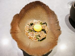 This quail egg was gently cooked in roasted bone marrow, cured mutton, and charred onions and then served with emulsified tapioca, onion jelly and parsley oil.