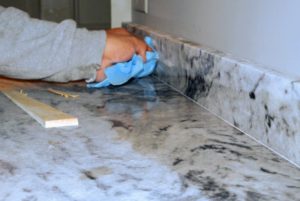 Once all the marble is in place, it is wiped down to remove any dust, finger prints or extra adhesive glue.