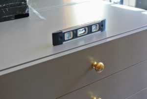 The dresser is also checked for perfect level. I chose my own drawer pulls for the dressers in the room.