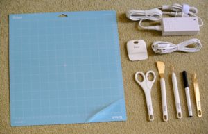 It comes with a Cricut 12-inch by 12-inch LightGrip cutting mat, tweezers, weeder, spatula, scissors and scraper, accessory adapter, power cord, plus more than 100 free images and project ideas.
