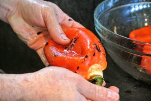 Pierre removes the skin from the pepper - it comes off very easily.