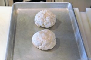 The dough is divided into two mounds and placed on a baking sheet - so easy to do. Now the biscuits are ready to go into the 400-degree Fahrenheit oven.